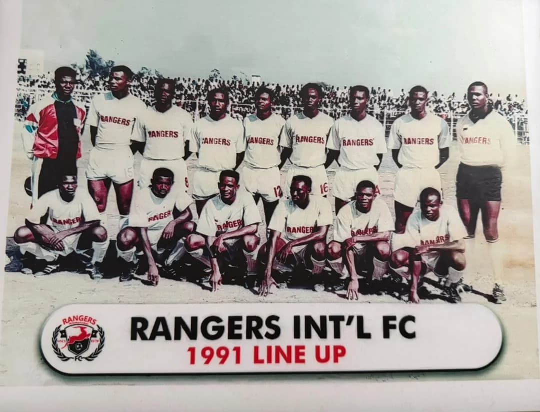 The 1991 Rangers squad in white shirts printed with RANGERS, in front of a packed stand.