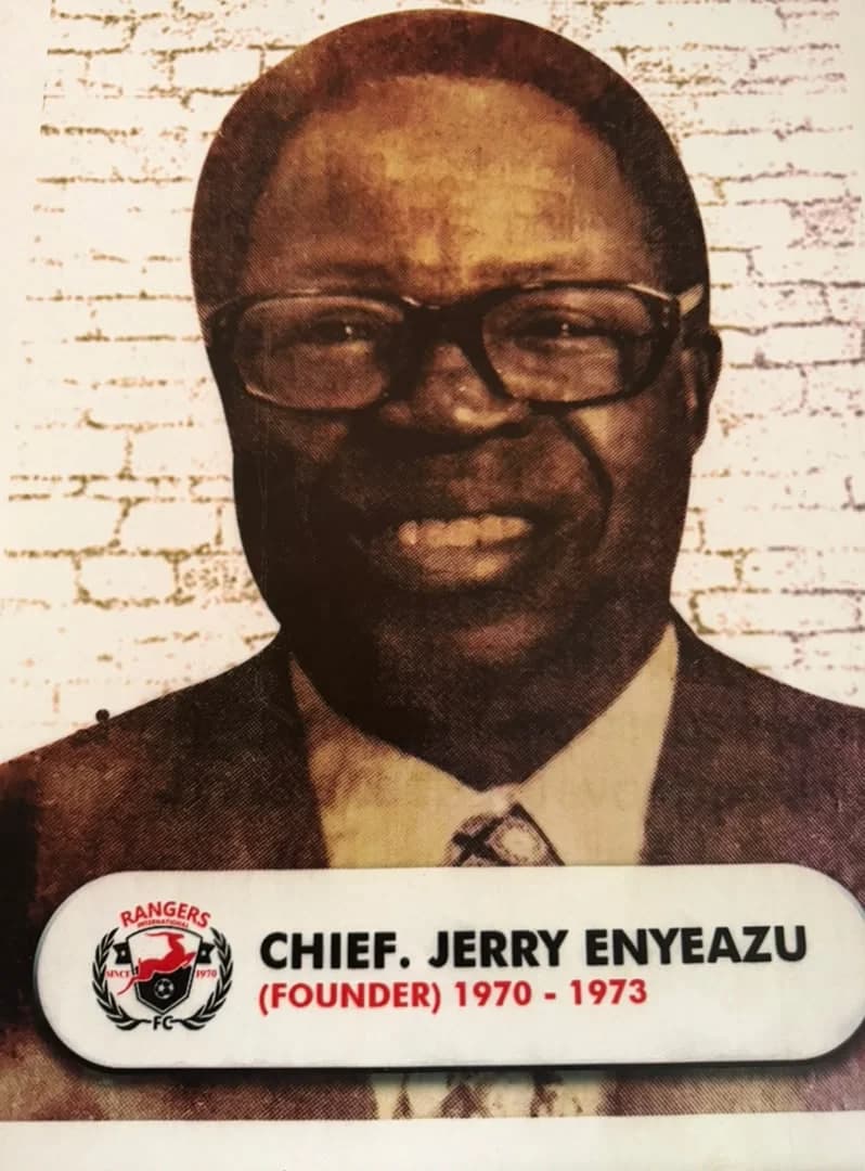 Portrait of Chief Jerry Enyeazu, founder of Rangers International F.C., in a suit and glasses.