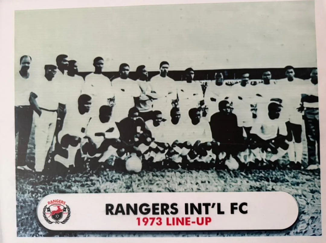 Black and white team photograph of the 1973 Rangers squad, standing and kneeling in white kit.