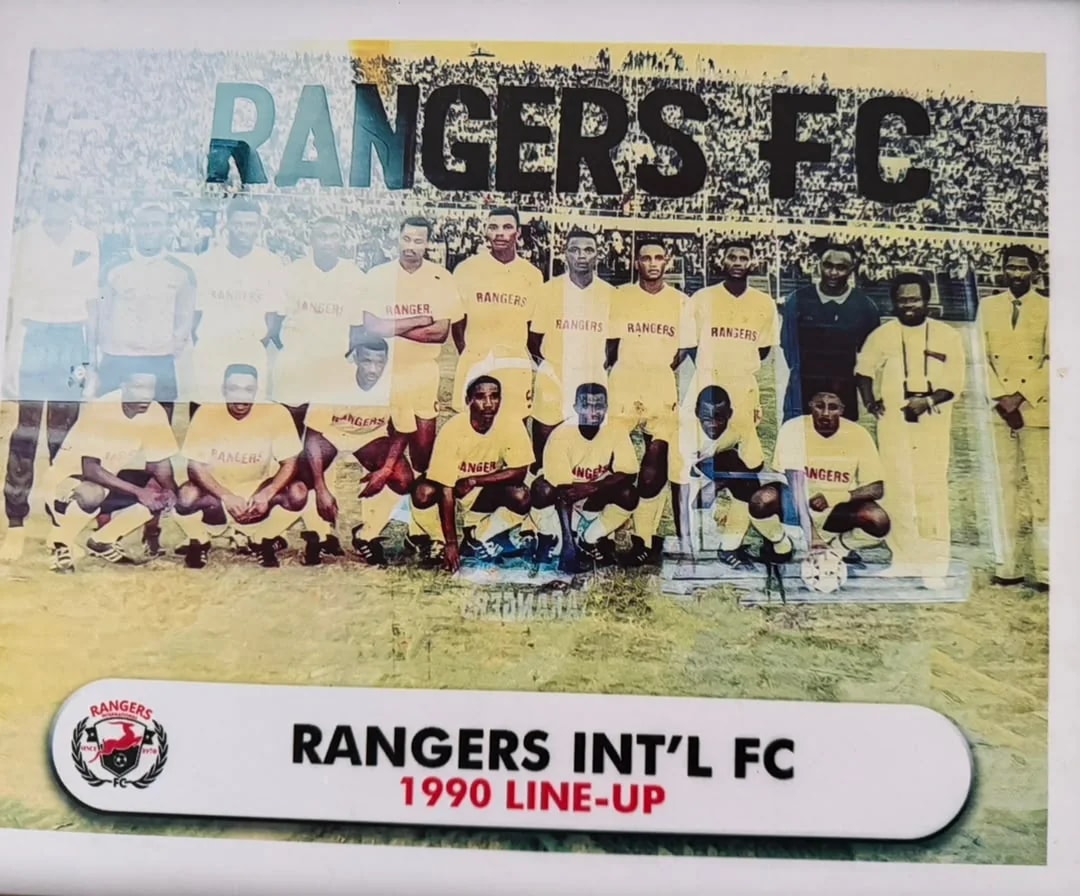 The 1990 Rangers squad in yellow kit beneath a Rangers FC banner, with officials in suits.