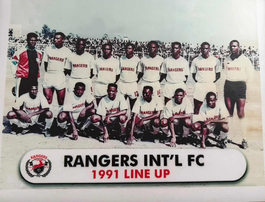 The 1991 Rangers squad in white shirts printed with RANGERS, in front of a packed stand.