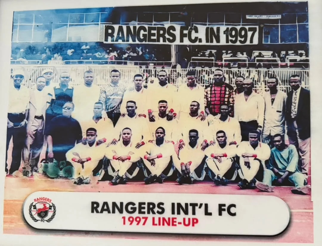 The 1997 Rangers squad and officials beneath a banner reading Rangers FC in 1997.